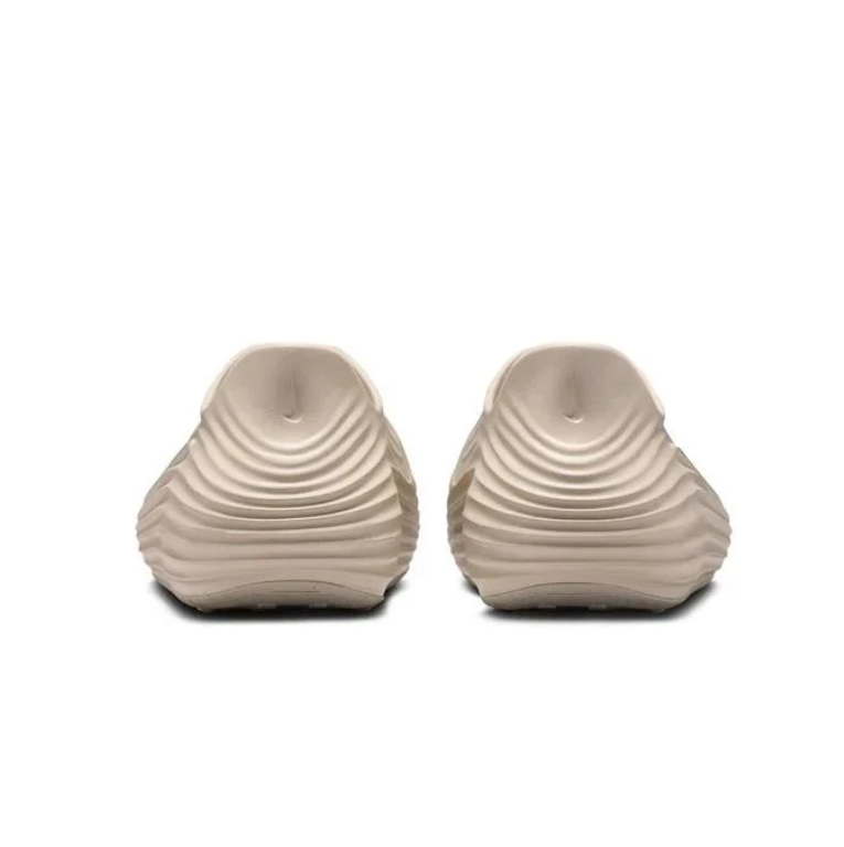 Nike Beige Slip-On Clogs with Vent Holes and Wave-Ridged Sides